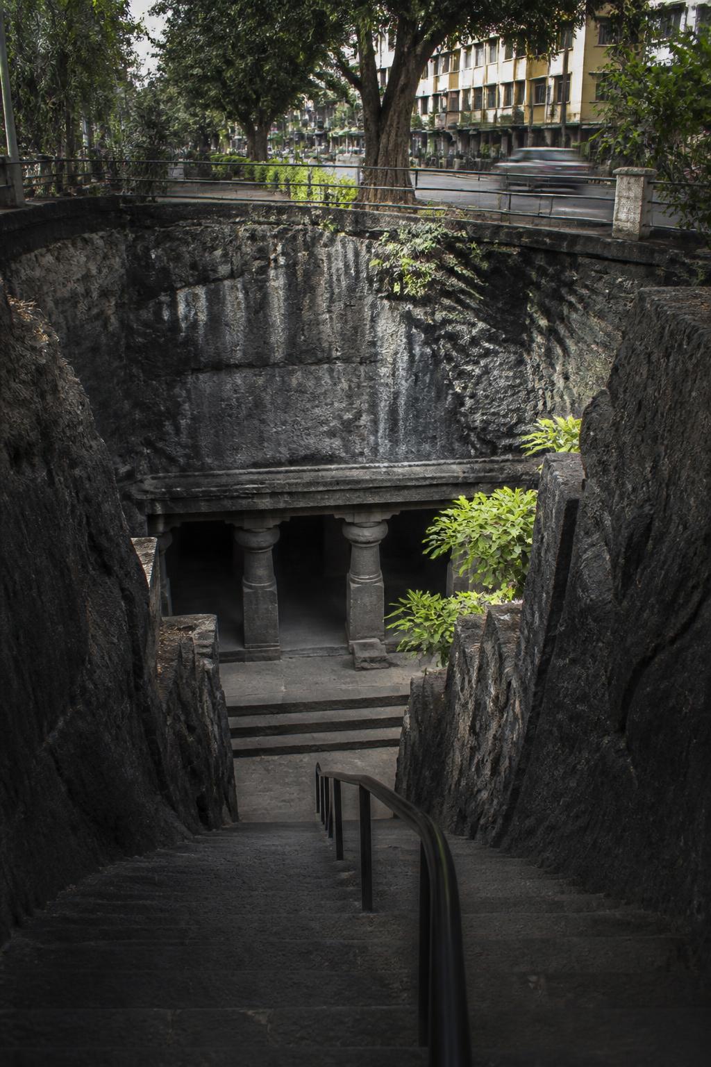 Steps descend from Pune’s modern street level into the ancient Pataleshwar cave temple.