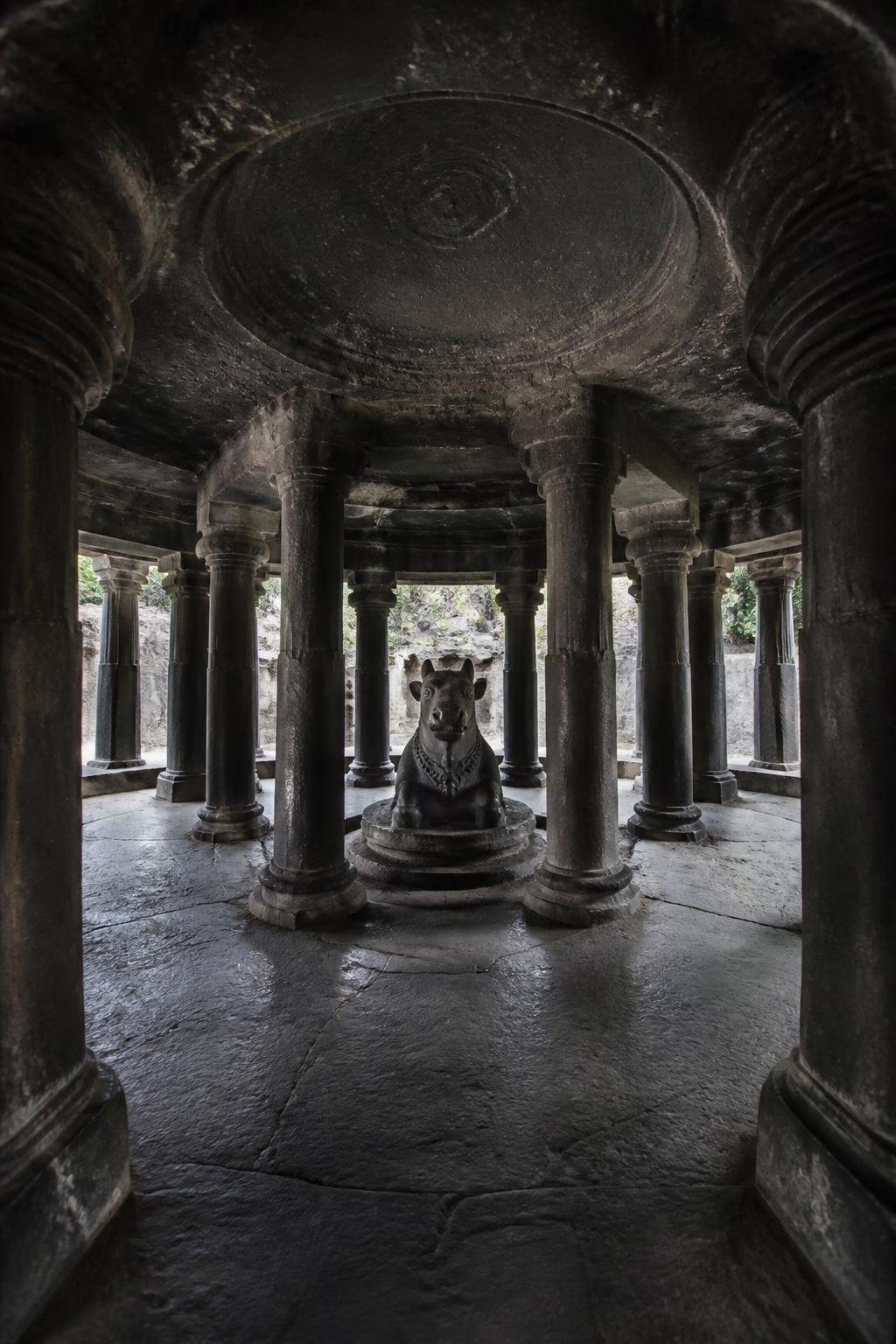 The circular rock-cut Nandi pavilion inside Pataleshwar Cave Temple.
