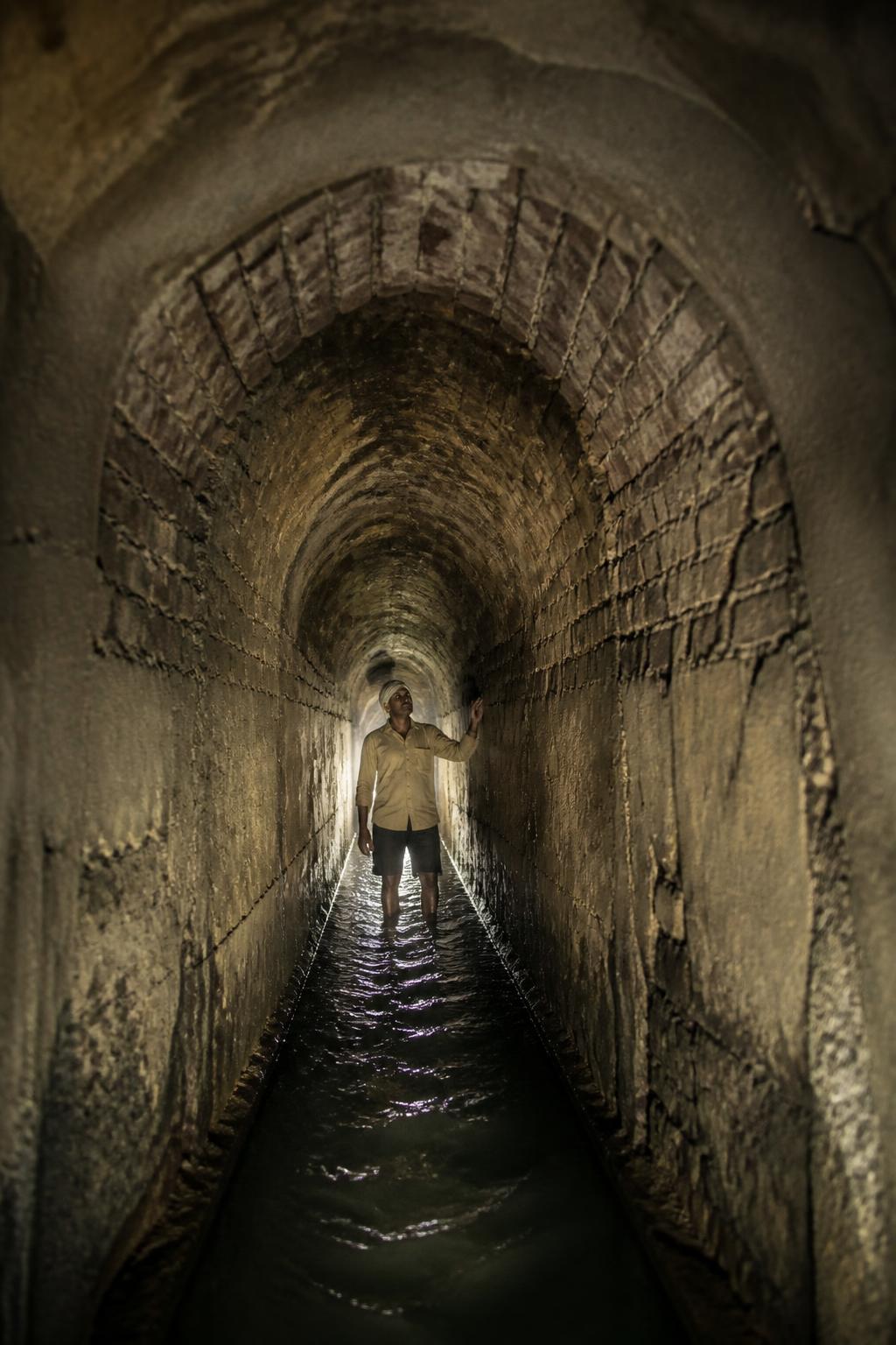 The walkable arched interior of Pune’s historic aqueduct.