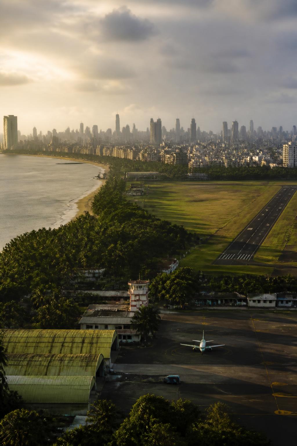 Juhu’s historic airfield set against Mumbai’s modern airport cityscape.