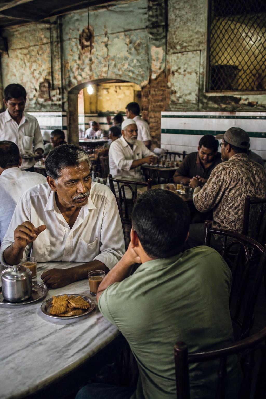 People sharing tea and Osmania biscuits in a Hyderabad Irani café.